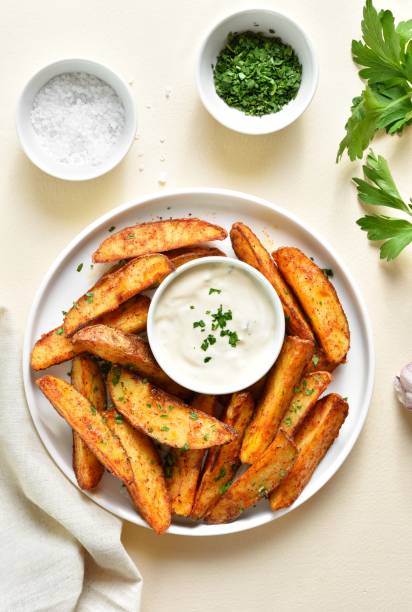 istock Oven baked potato wedges with sauce 1953024467