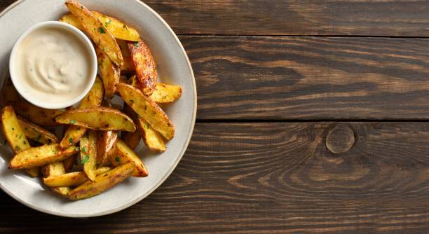 istock Baked potato wedges with sauce 1953024551