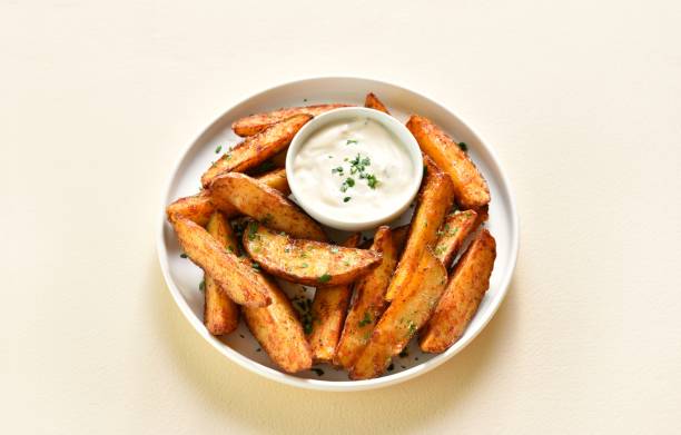 istock Oven baked potato wedges with sauce 1953024552