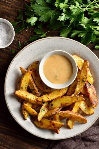 istock Baked potato wedges with sauce 1953024580