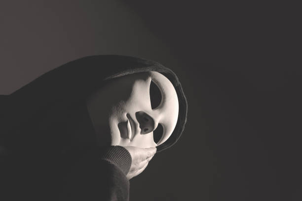 istock thinking man with face covered by a mask, abstract concept 1953074776
