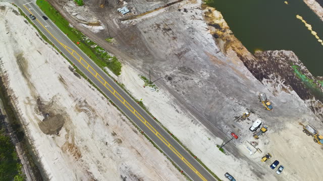 Aerial view of american highway under construction with moving traffic. Development of road infrastructure. Miami, USA - April 1, 2023.