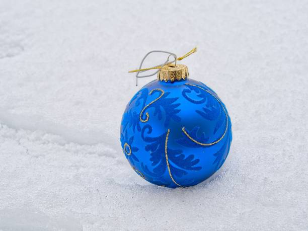 Realistic blue matte Christmas ball with ribbon isolated on a white background. High resolution.