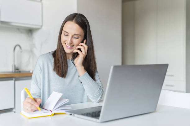 istock Charming young woman using laptop computer for working from home 1953115917