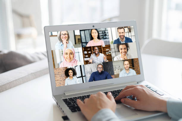 istock Woman using laptop for video conference, back view 1953116484