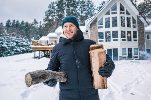Young man starting outdoor fire in winter