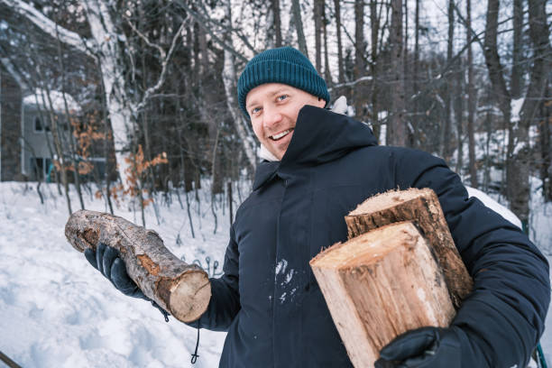 istock Young man starting outdoor fire in winter 1953126503