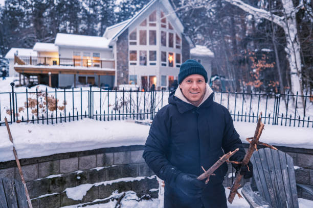 istock Young man starting outdoor fire in winter 1953129186