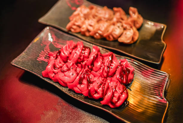 istock Vibrantly colored duck gyozas on a sleek black plate 1953132874