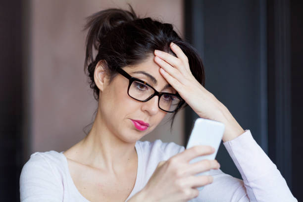 istock Sad Woman  using her phone at home 1953183237
