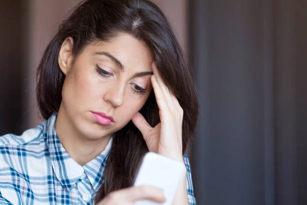 istock Sad Woman  using her phone at home 1953187407