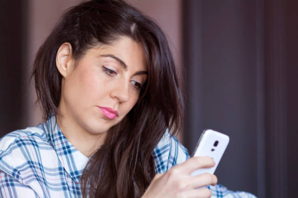 istock Sad Woman  using her phone at home 1953187411