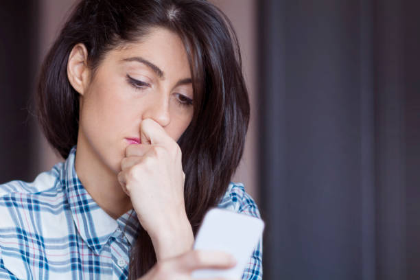 istock Sad Woman  using her phone at home 1953187419