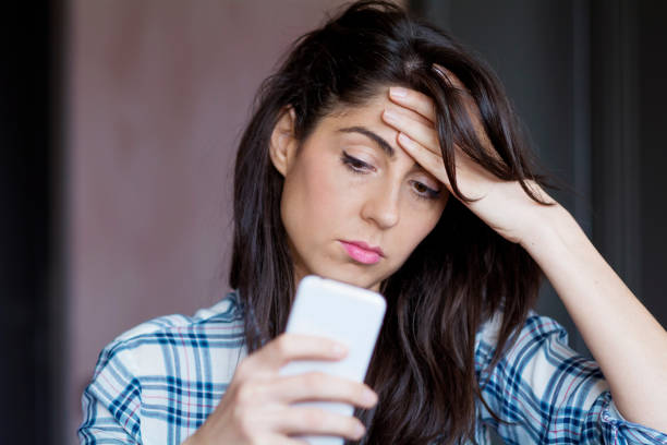 istock Sad Woman  using her phone at home 1953187949