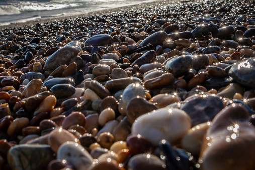 Pebble stones on the shore close up.