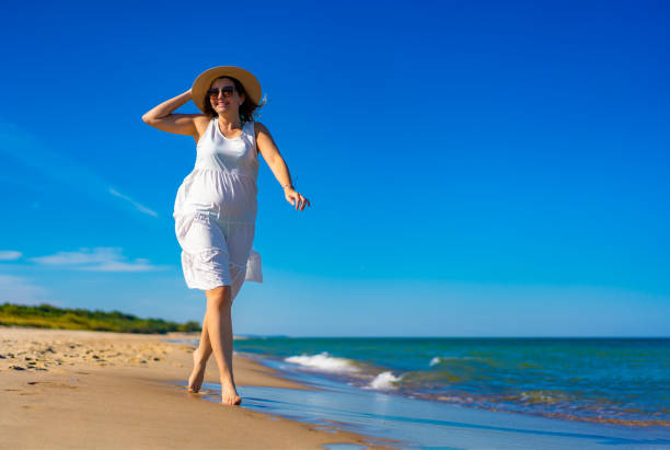 istock Beautiful woman walking on beach 1953201201