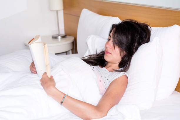 istock Woman  reading book in the bed 1953205423