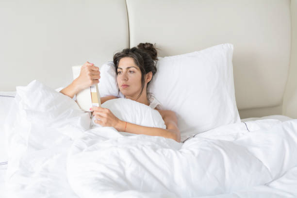istock Woman  reading book in the bed 1953208022