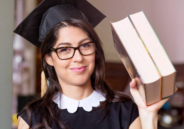 istock Happy smiling young woman wearing graduation cap 1953217882
