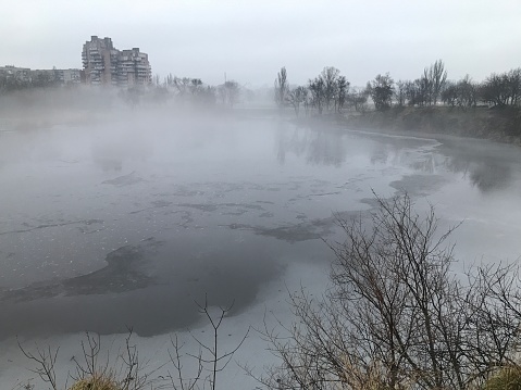 Fog above frozen lake