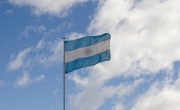 istock Argentine flag over blue sky 1953251657