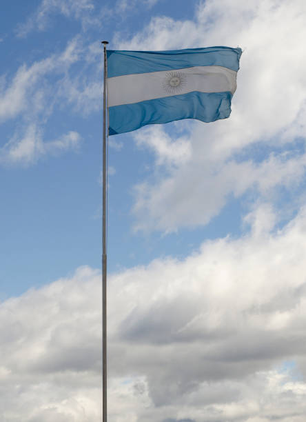 istock Argentine flag over blue sky 1953251658