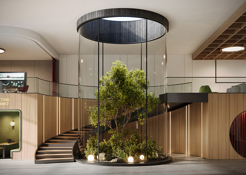 Interior of a large office space with spiral staircase. Digital generated image of a green office lobby space.