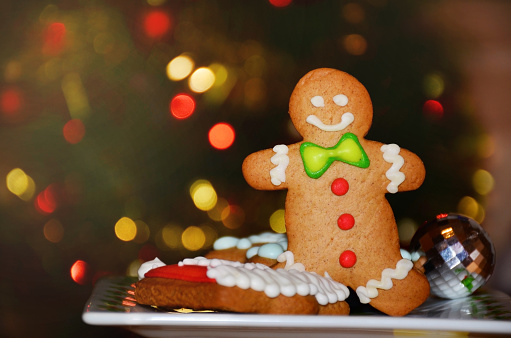 Gingerbread man cookie on a Christmas lights background