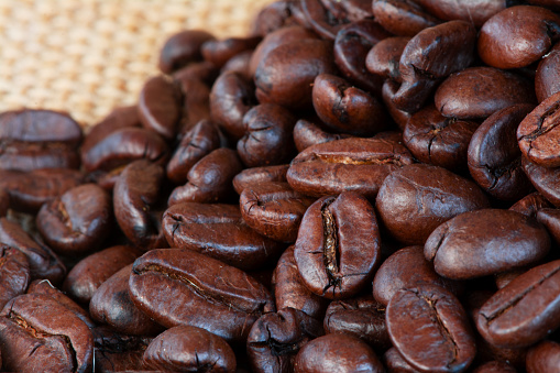 Freshly baked  dried coffee beans on background