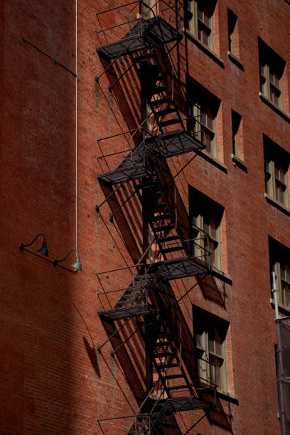 istock Old fire escape on an old brick wall. American vintage style. 1953276547