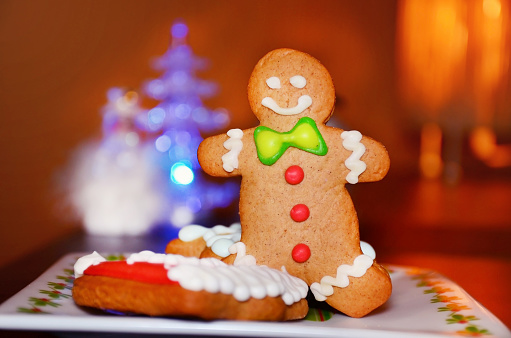 Gingerbread man cookie on Christmas lights background