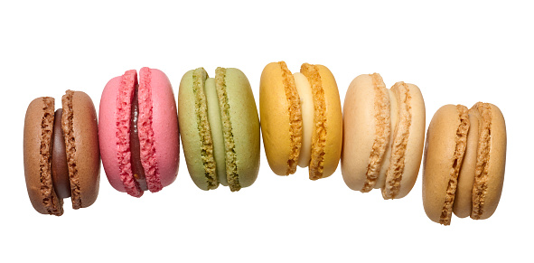 Multicolored baked macarons on isolated background