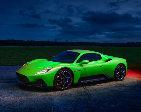 Green  Maserati MC20 standing against the backdrop of the evening landscape. Engine 3.0l V6 Twin Turbo, 630 HP, 730 Nm, Max speed 325 km-h, RWD. Katowice, Poland, 23.09.2021