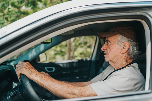 Senior man traveling by car