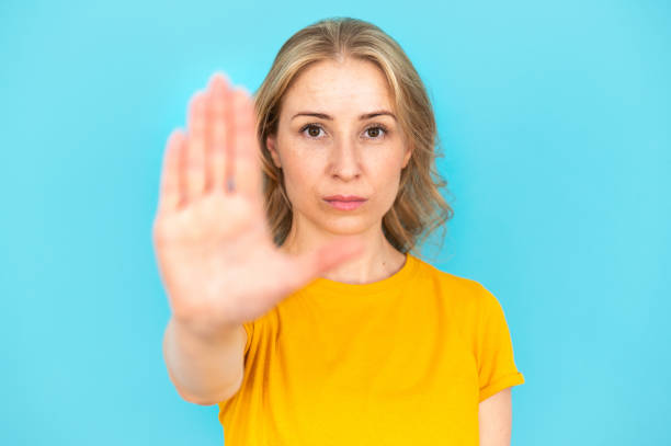 istock Woman outstretched her hand, showing stop gesture 1953322424