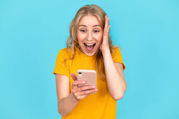 istock Shocked young woman looking at modern cellphone display 1953324039