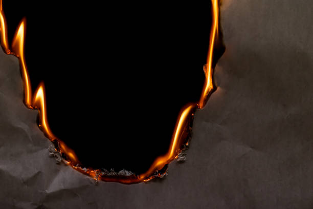 istock burning paper, glowing edge of paper 1953359895