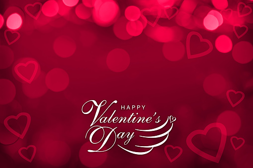 Red defocused lights background with glowing hearts and HAPPY VALENTINE'S DAY text. Can be used as a design for Valentine's day holiday greeting cards or posters.