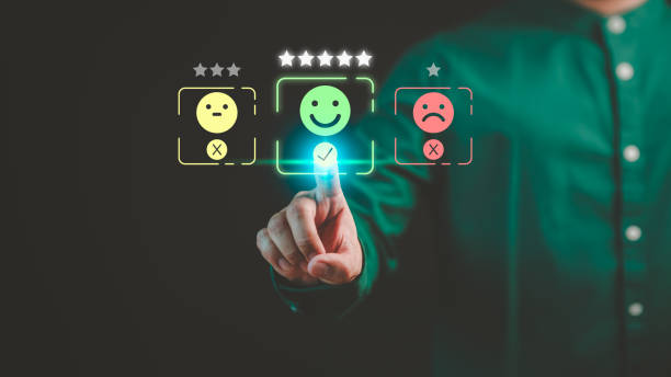 istock Customer hand touching the virtual screen on happy smile face icon to give satisfaction in service. Concept of assessment testimonial customer service and feedback, Opinion rating very impressed. 1953473604