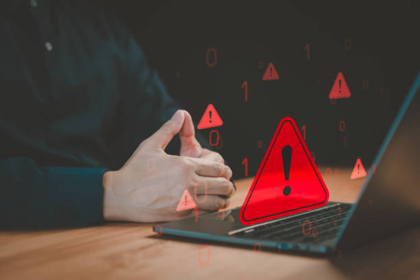istock Male user use computer laptop with caution warning sign for notification error. Concept cyber security technology of computer virus detect, personal data protection, network security and maintenance. 1953478014