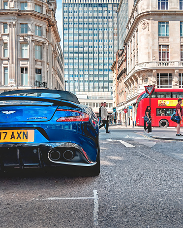 London - 16 June 2018 - British Blue Sports Car in London City Street with Red Double Decker Bus, London UK