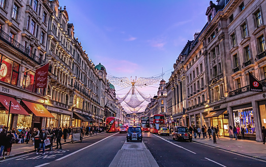 London - 17 November 2017 - Festive Christmas Scene at Sunset in Regent Street with Black Taxi and Angels, London UK