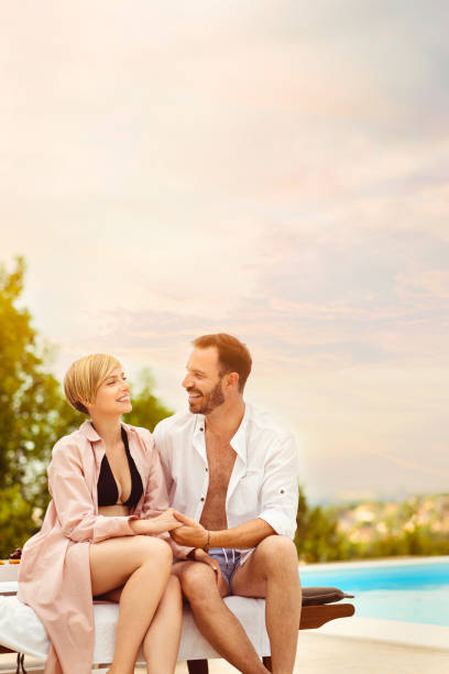 istock A couple in love sitting by the pool 1953483029