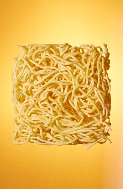 istock Dried Noodles Against a Yellow Background 1953590615