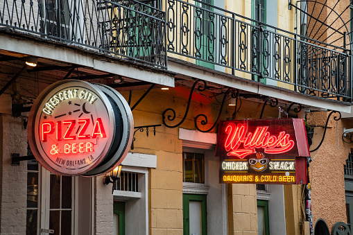 New Orleans, LA - October 21, 2023: Pizza and Chicken Restaurant and Bars on Bourbon Street.