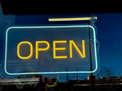 Colorful Neon OPEN Sign in Window Close-Up