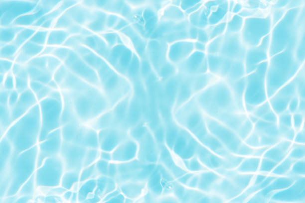 istock Bluewater waves on the surface ripples blurred. Defocus blurred transparent blue colored clear calm water surface texture with splash and bubbles. Water waves with shining pattern texture background. 1953665434