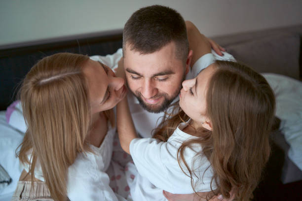 istock parents play with their daughter 1953680228