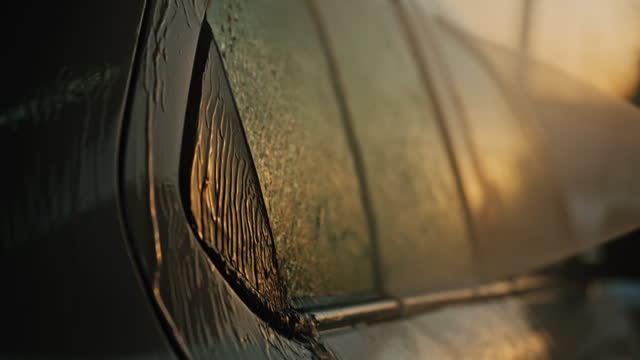 SLO MO Closeup of High Pressure Water Gun Washing Car Window at an Outdoor Self-Service Car Wash Station During Sunset