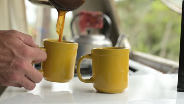 Hands, coffee and french press with person in kitchen for preparation of caffeine beverage closeup in home. Morning, cup or mug and pouring drink in apartment for start or beginning of daily routine